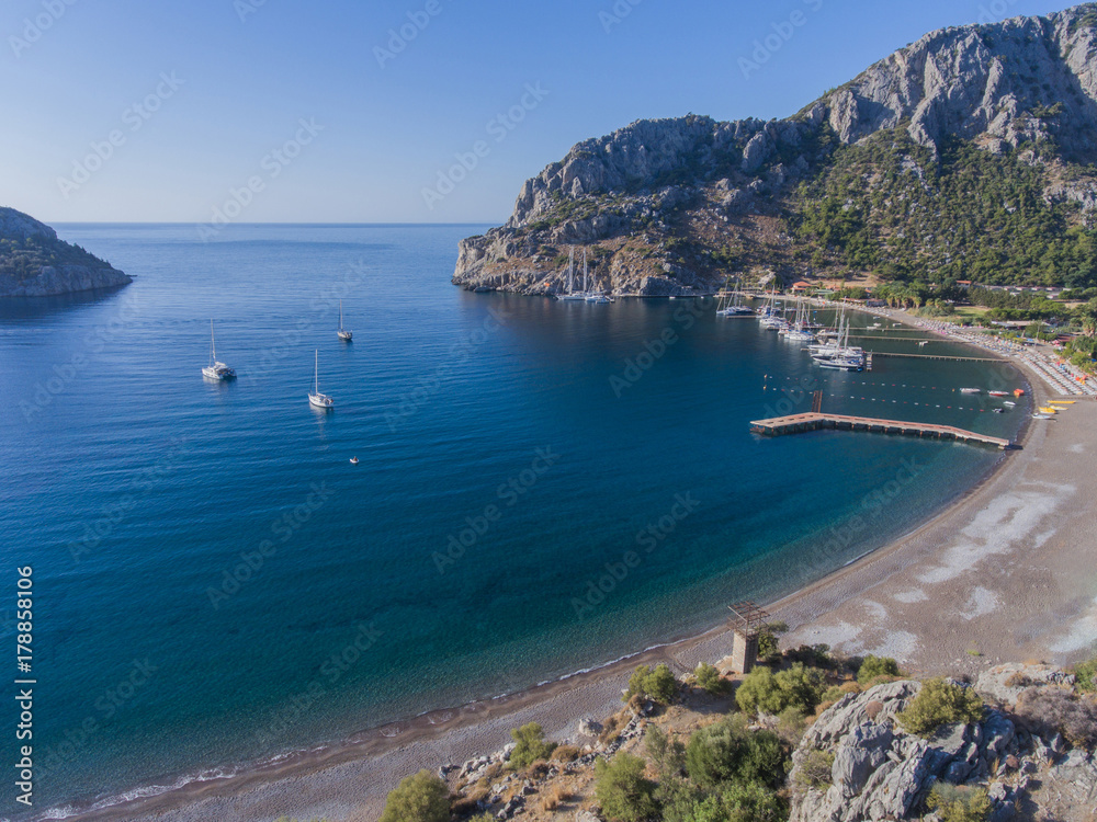 Bending a pebble beach. Resort area in the Bay on the Mediterranean coast of Turkey