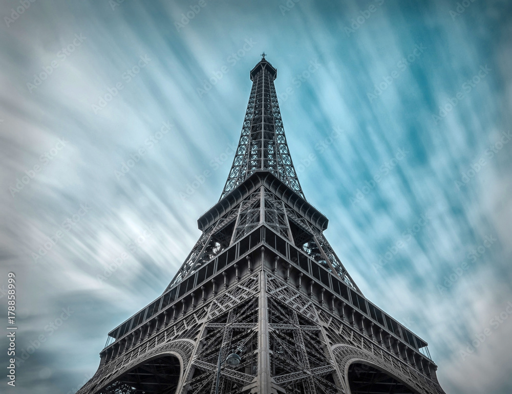 Eiffel Tower under motions clouds. Beautiful view on one of famo