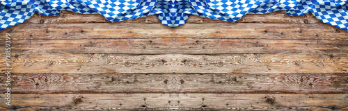 Rustic background for Oktoberfest with bavarian white and blue fabric on wooden