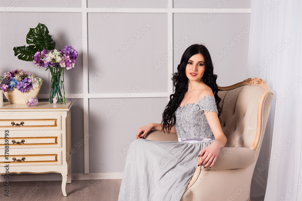 young woman in elegant blue gray evening dress indoors with beautiful interior young woman in elegant blue gray evening dress indoors with beautiful interior