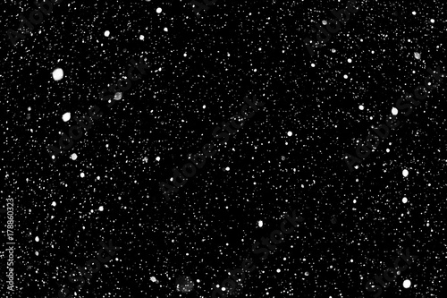 Flakes of snow on a black background. Isolated