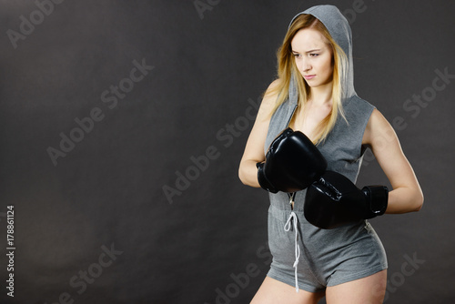 Boxer girl exercise with boxing gloves. © anetlanda