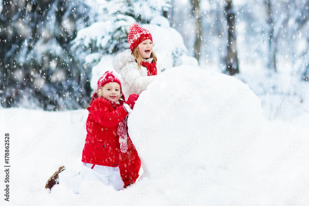 Kids building snowman. Children in snow. Winter fun. Kids building snowman. Children in snow. Winter fun.