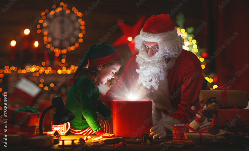 Santa Claus and little elf with magic gift for Christmas. Santa Claus and little elf with magic gift for Christmas.