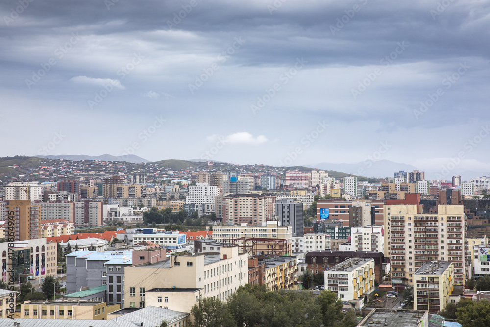 city of Ulaanbaatar, Mongolia, with a cloudy sky over it 