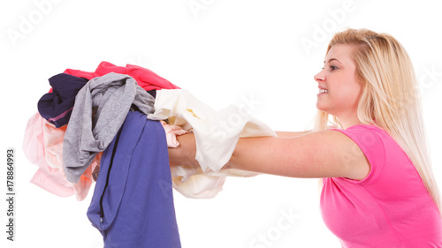 Woman having a lot of clothes to iron