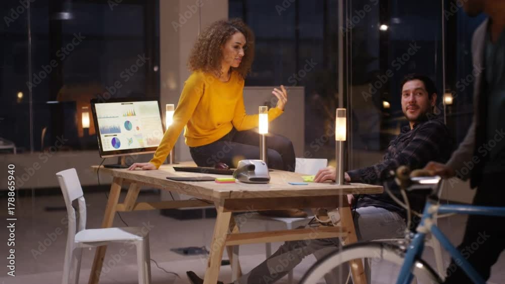 Businessman with bicycle arrives at office for late meeting with colleagues Businessman with bicycle arrives at office for late meeting with colleagues