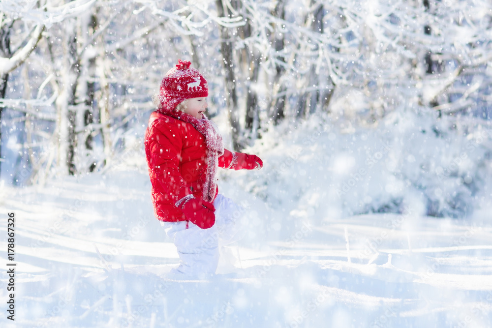 Child playing with snow in winter. Kids outdoors. Child playing with snow in winter. Kids outdoors.
