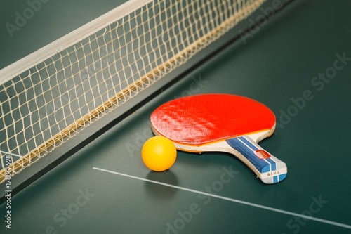 Table Tennis Racket and Ball on Table with Net