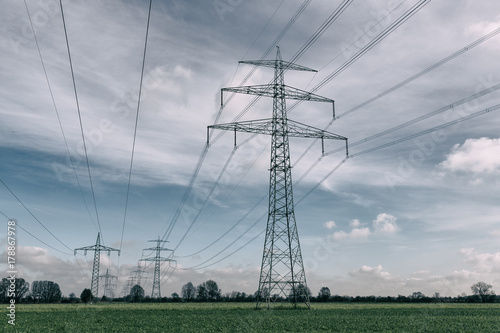power lines over green field