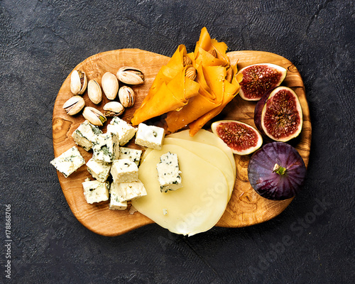 Italian snacks food with Cheese and Figs on concrete background with copy space