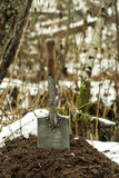 RUSSIA, PERM - SEPTEMBER, 30, 2017: Imperial Russian WW1 Infantry Flat Shovel, stuck in the earthen embankment against the background of a blurred snow-covered landscape