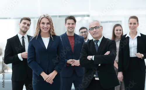 businessman and business woman standing in front of the business team.