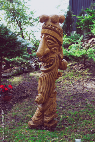 Wooden devil statue in the forest