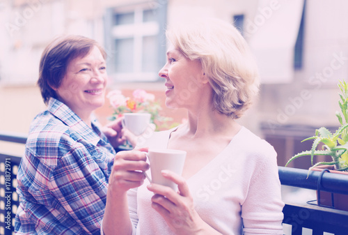 Old women on balcony with tea