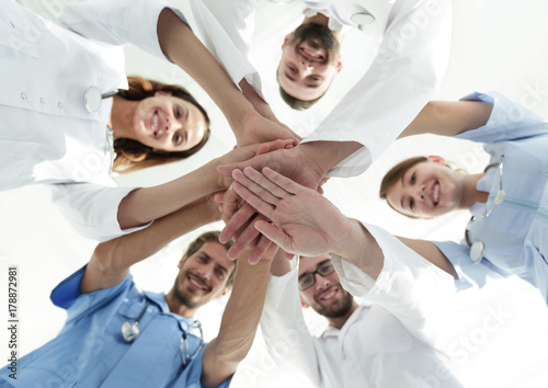 bottom view.a team of doctors at the medical center clasped their hands together