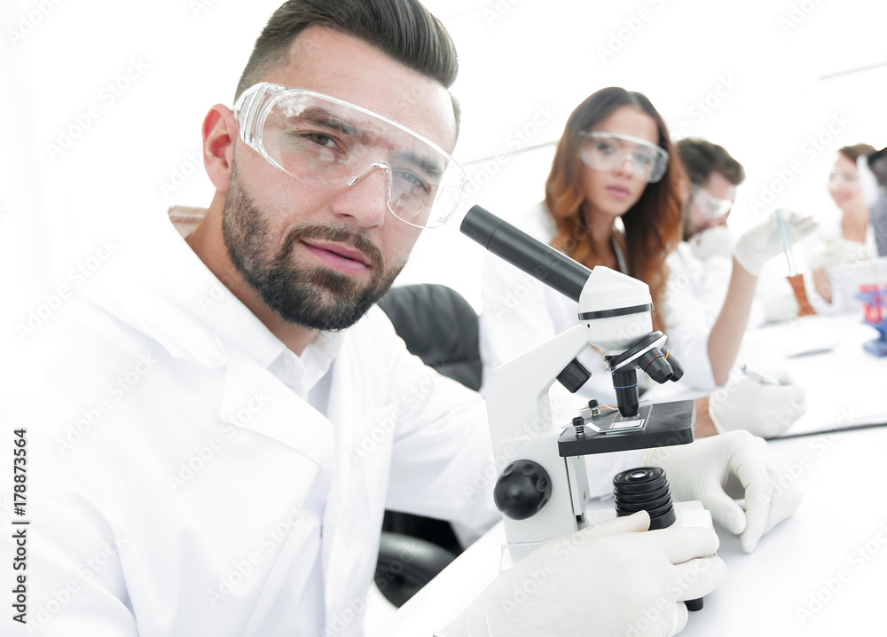 close-up of a scientific researcher with microscope close-up of a scientific researcher with microscope