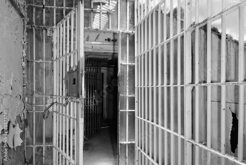 Tablou pe pânză Open metal barred gates inside an old prison