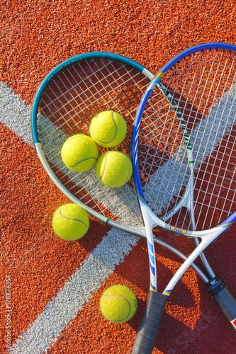 Tennis Rackets and Balls on a Tennis Court © BillionPhotos.com