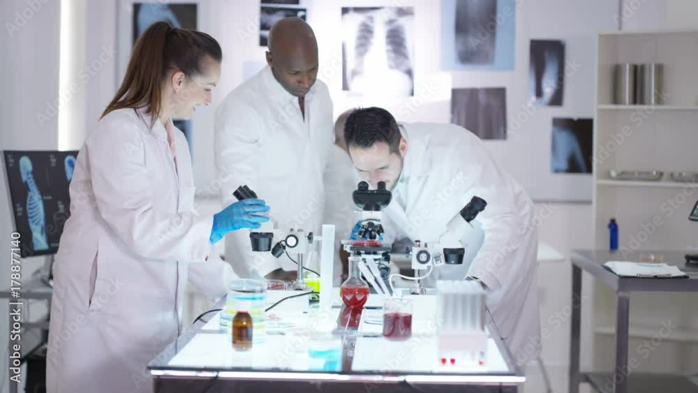 Happy medical research team make a discovery in the lab. Happy medical research team make a discovery in the lab.