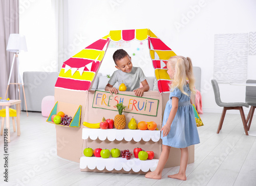 Cute little boy selling fru...