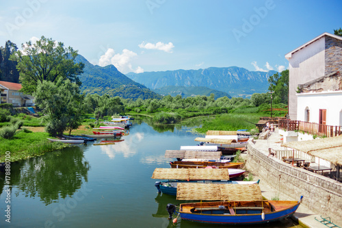 Lake Skadar National Park. Boat with a thatched roof on the pier photo