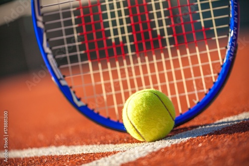 Tennis Racket and Ball on a Tennis Court © BillionPhotos.com