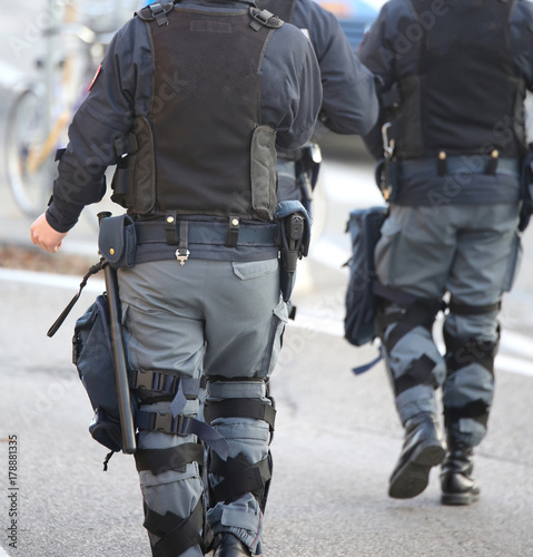 two anti-riot police cops patrol the streets of the