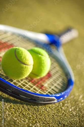 Tennis Racket and Balls on a Tennis Court © BillionPhotos.com