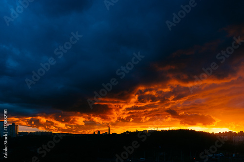 Panoramic view of apocalypse sky over city. Unbelievable nature landscape. Fantastic and outlandish stormy clouds. Warm and cold. Heaven battle. Hell and heaven fight. Colorful impressive paysage.