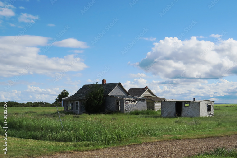 Many old houses and a storage unit in the middle of a field in Saskatchewan, Canada. Many old houses and a storage unit in the middle of a field in Saskatchewan, Canada.