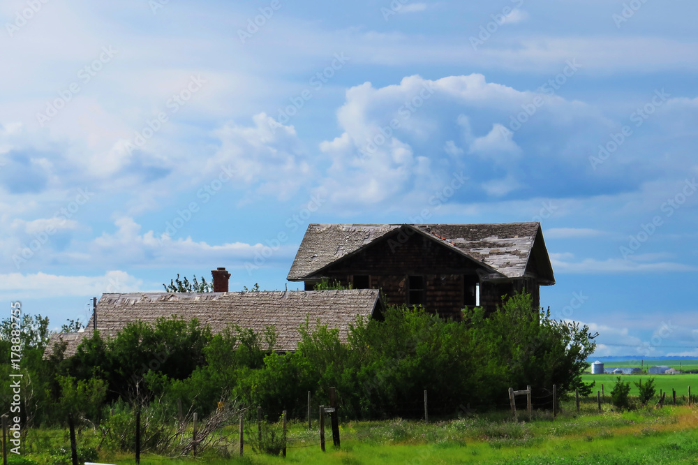 Old abandoned houses in the middle of a field in Saskatchewan, Canada.