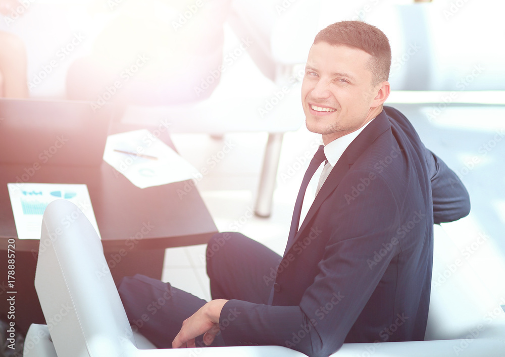 Successful business man with his staff in background at office Successful business man with his staff in background at office