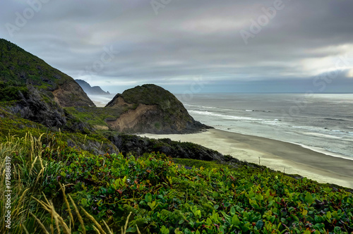 View across beach with mist and clouds with green and Coastel Vi photo