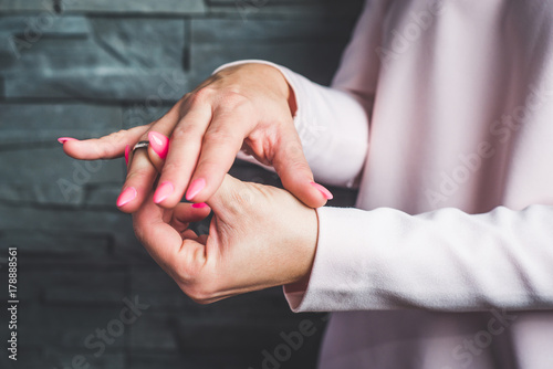 Put a ring on your finger. The woman assumes a ring on her finger  a ring. Engagement concept  marriage  respect  fidelity  duty.
