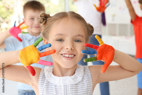 Little girl with hands in p...