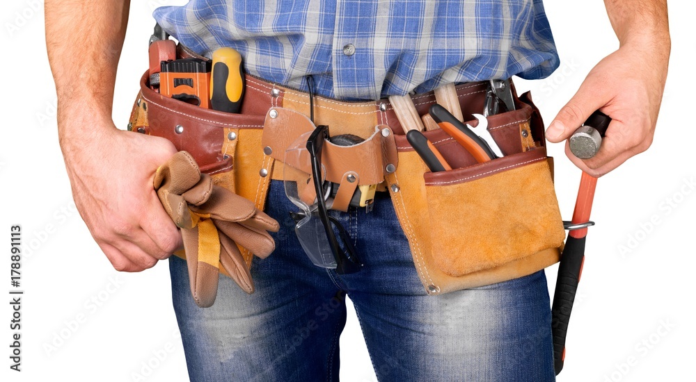 Young man worker in uniform with yellow belt and tools Young man worker in uniform with yellow belt and tools