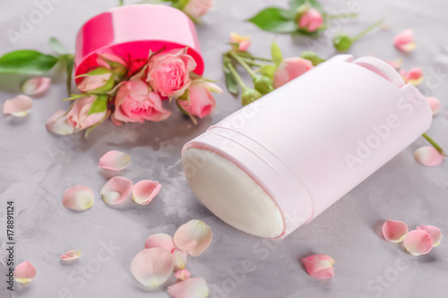 Deodorant for women and flowers on table