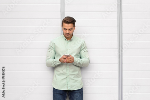 Young handsome man using hi...