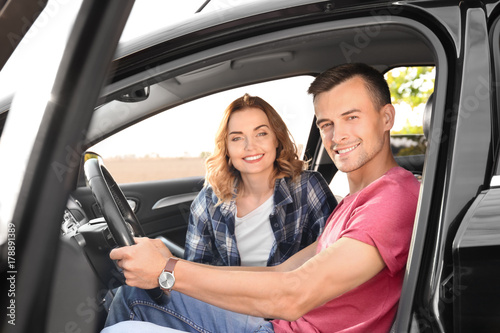 Beautiful young couple in car