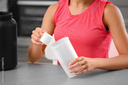 Woman preparing protein shake indoors