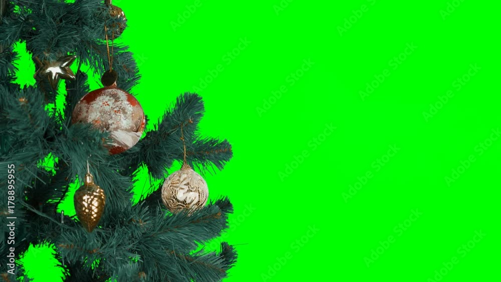 A big red ball hangs on branch of Christmas tree and rotates. Alpha Channel transparent background. Concept for Merry Christmas and Happy New Year greeting video cards. Slow motion locked down.