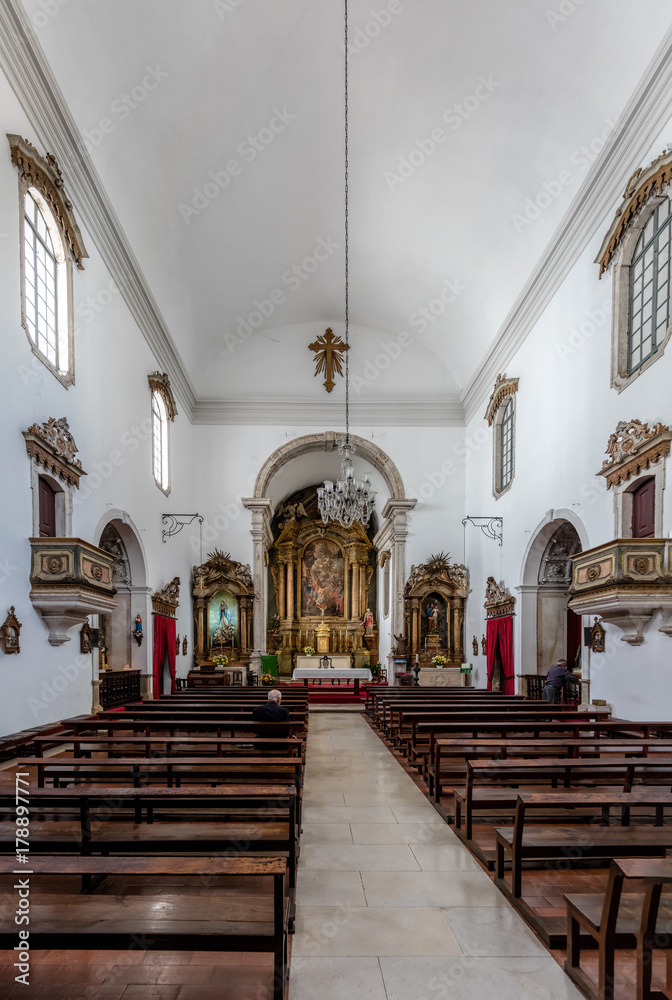 Interior of the Saint Bartholomew Church, originated in the 10th century, rebuilt in the 18th century, features a 16th century Mannerist altarpiece. Coimbra, Portugal.