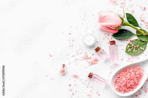 Natural cosmetic with rose oil on white background top view copyspace