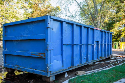 roll-off dumpster filled with building rubble photo