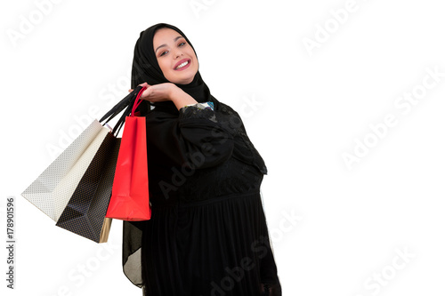 Arabian woman carrying shopping bags isolated on white © FS-Stock