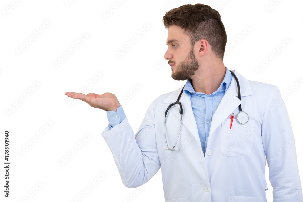Portrait of a smiling male doctor pointing finger away isolated on a white background Portrait of a smiling male doctor pointing finger away isolated on a white background