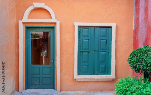 Vintage green window and door on orange wall