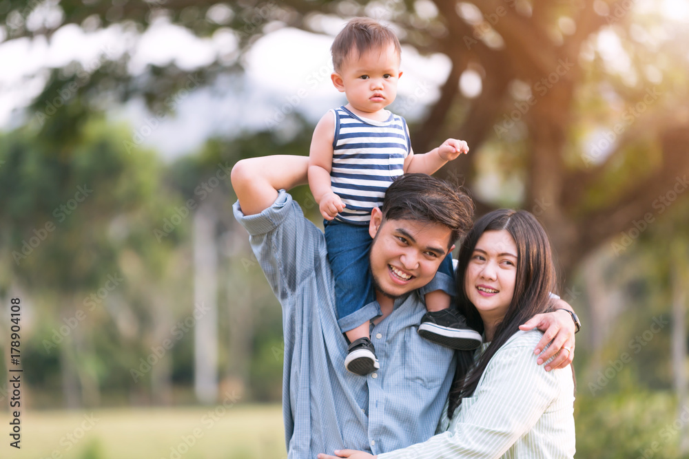 Happy mother and father playing his little son in park. Happy mother and father playing his little son in park.