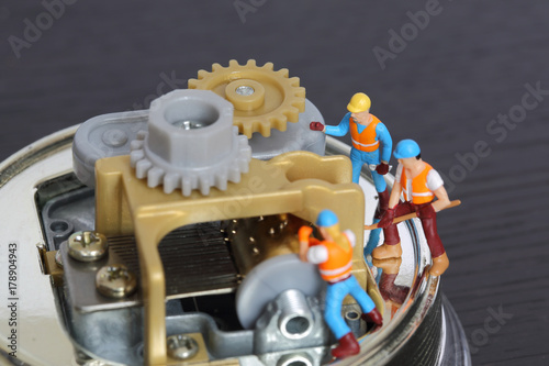 Selective focus of miniature engineer and worker to fixed and repair musical box and use for business background.